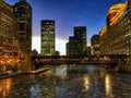 View of frozen Chicago River and elevated track during evening sunset at rush hour. Royalty Free Stock Photo