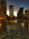 View of frozen Chicago River and elevated track during evening sunset at rush hour with ice chunks on river. Royalty Free Stock Photo