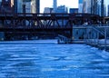 View of frozen Chicago River and riverwalk on a blue, frigid morning in winter. Royalty Free Stock Photo