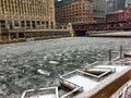 View of frozen Chicago River and snow-covered riverwalk. Royalty Free Stock Photo