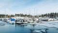 A View of frozen dock with boats in Coal Harbour. Snow storm and extreme cold weather in Vancouver Royalty Free Stock Photo