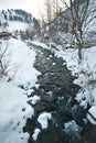 View of frozen river countryside. Brook in snowy landscape. Romanian small river in winter scenery, Romania, Moeciu. Wild brook Royalty Free Stock Photo