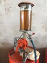 View of Fuel dispenser machine and large metal barrels