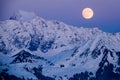 Full moon rising over a winter mountain landscape Royalty Free Stock Photo
