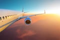 View of the fuselage, wing engine and tail. Airplane flies on the flight level during the time of sunset. Royalty Free Stock Photo