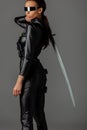 View of futuristic african american woman in glasses with sword isolated on grey Royalty Free Stock Photo