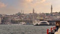 View from Galataport overlooking Karakoy ferry terminal with docked boat and Yeni Cami or New Mosque Istanbul, Turkey Royalty Free Stock Photo