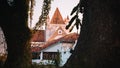 View of the Galle fort library and the all saint`s church roofs through the two large trees. Evening light hits the rooftops and