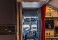 View from the galley into the cockpit of a commercial aircraft in cruise - the pilot is currently switching the systems