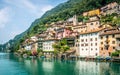 View of Gandria fishermen village with colorful houses on Lake Lugano lakeside on beautiful summer day in Switzerland