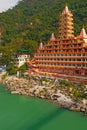 View of Ganga river embankment, Lakshman Jhula bridge and Tera Manzil Temple, Trimbakeshwar in Rishikesh Royalty Free Stock Photo