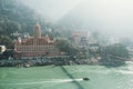 View of Ganga river embankment, Lakshman Jhula bridge and Tera Manzil Temple, Trimbakeshwar in Rishikesh. Royalty Free Stock Photo