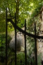 View of garden bench through an open wrought iron gate