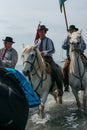 Gardians and camargue horses in the sea Royalty Free Stock Photo