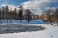 View of the Gatchina Palace from the White Lake. Winter. In the water of the pond there are many birds - ducks and Royalty Free Stock Photo