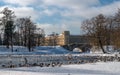 View of the Gatchina Palace from the White Lake. Winter. In the water of the pond there are many birds - ducks and Royalty Free Stock Photo