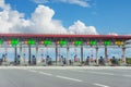 View gate for cars at the entrance to the toll road, limited by the barrier. Cashless payment transponder, speed limit signs