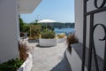 A view through a gate to a sunny Mediterranean terrace.