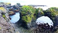 View of Gatklettur Arch Rocks Formation with seabirds flying