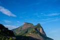 View of the Gavea Stone, seen from the street with houses on the hill during late afternoon. Barra da Tijuca, Rio de Janeiro