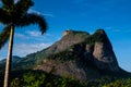 View of the Gavea Stone, seen from the street with houses on the hill during late afternoon. Barra da Tijuca, Rio de Janeiro