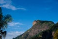 View of the Gavea Stone, seen from the street with houses on the hill during late afternoon. Barra da Tijuca, Rio de Janeiro