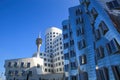 View on Gehry houses with silver shiny futuristic metallic aluminium facade with tv tower