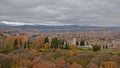 View on Generalife gardens, city of Granada and Sierra Nevada mountains from Alhambra castle, Granada, Spain on a cloudy day Royalty Free Stock Photo