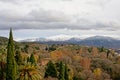 View on Generalife gardens and Sierra Nevada mountains from Alhambra castle, Granada, Spain on a cloudy day Royalty Free Stock Photo