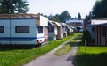 View of german camping place with tents, caravans, trailer park and cabin cottage houses