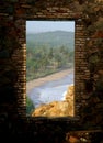 View on a Ghanaian beach through the window of an ancient castle Royalty Free Stock Photo