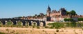 Gien cityscape on bank of Loire with medieval castle and arched bridge