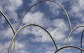 View of gigantic, modern sculpture with cloudy blue sky Royalty Free Stock Photo