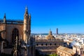 View from the Giralda Tower out over roof and spires of the Seville cathedral with the city in view in Seville, Spain Royalty Free Stock Photo