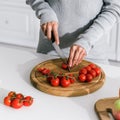 View of girl cutting red cherry tomatoes Royalty Free Stock Photo