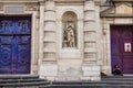 View of Girl at the huge wooden doors to Saint Etienne du-Mont Church, Latin Quarter, Paris France