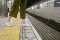 View of girl`s legs and waiting for train coming Royalty Free Stock Photo