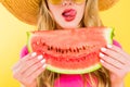 View of girl sticking tongue out and holding watermelon On yellow Royalty Free Stock Photo