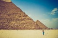 View of the Giza Pyramids and photographer tourist near them. Egypt. Cairo. Royalty Free Stock Photo