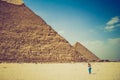 View of the Giza Pyramids and photographer tourist near them. Egypt. Cairo.