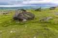 A view of a glacial erratic perched on a limestone base on the southern slopes of Ingleborough, Yorkshire, UK Royalty Free Stock Photo