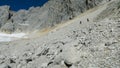 View of the glacier in the alps and tourists marching on it