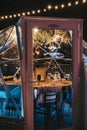 View through the glass inside Jimmys Lodge Snow Globes pop up restaurants in Southbank, London, UK Royalty Free Stock Photo