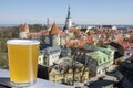 View of glass of light beer with background of the Old Town in Tallinn Royalty Free Stock Photo