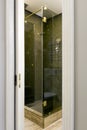 View of the glass shower through the doorway with a moving door on its side. Royalty Free Stock Photo