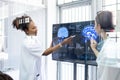 View through glass, Team doctor presentation of brain x-ray results through screen to present to medical team in meeting room. Royalty Free Stock Photo