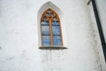 View of a glass window with brown metal framing on a white painted wall