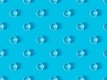 View of glasses of water on blue, seamless background pattern