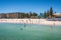 View of Glenelg beach full of people in Adelaide suburb on hot sunny summer day in South Australia Royalty Free Stock Photo