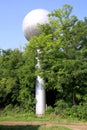 View of globular water tower at village farm between trees Royalty Free Stock Photo